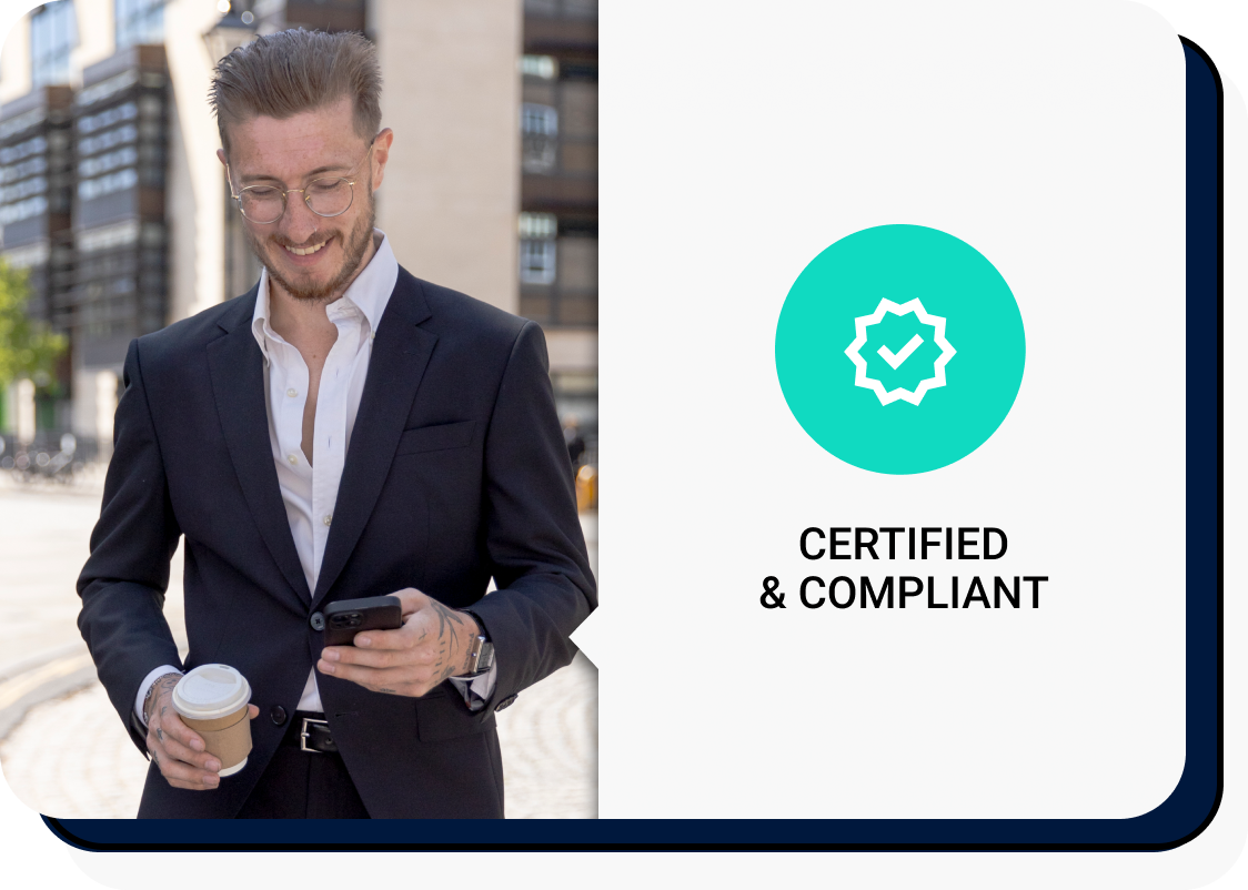 A man in a suit walking through the city on his phone