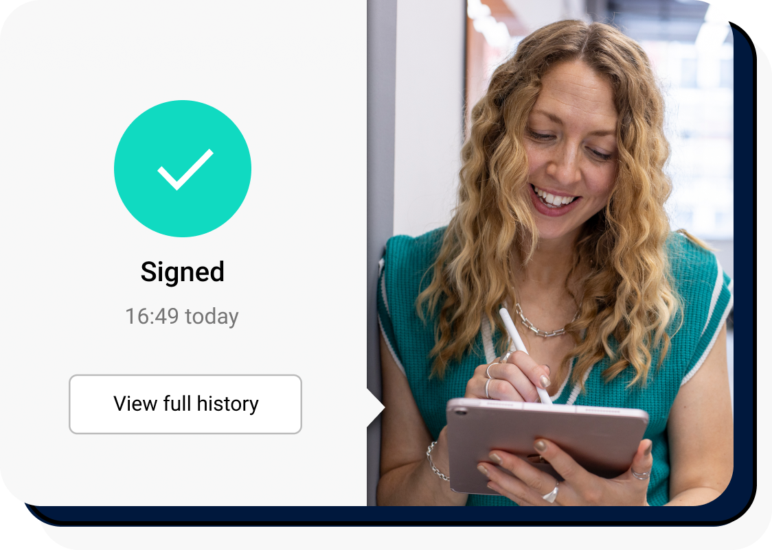 A woman smiling at an ipad whilst signing electronically