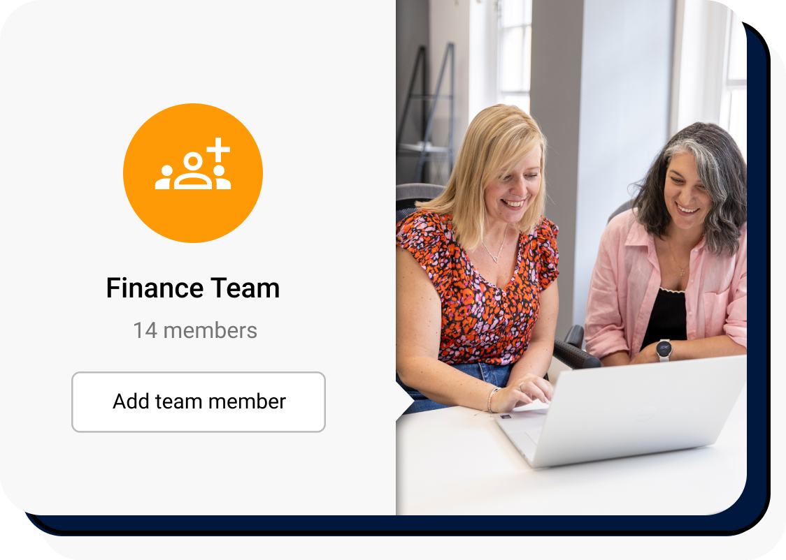 Two women looking at a laptop in a bright and airy office