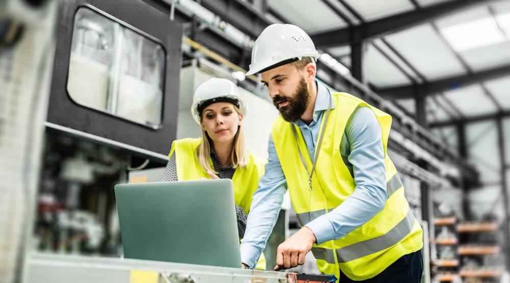Manufacturing workers looking at laptop