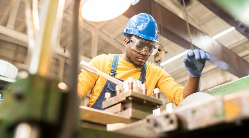 Manufacturer worker in blue hard hat