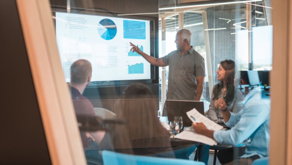 Digital agency office members discussing charts